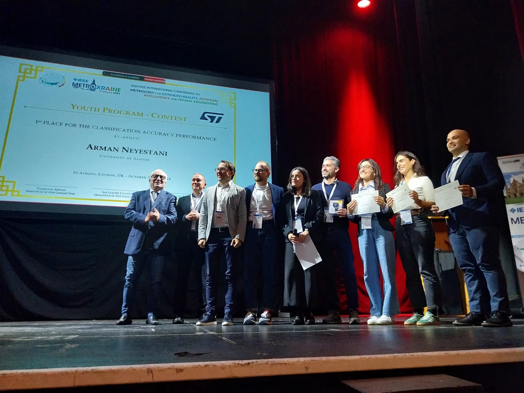 Arman Neyestani and the MetroXRAINE Young Researchers Program award recipients on stage in London.